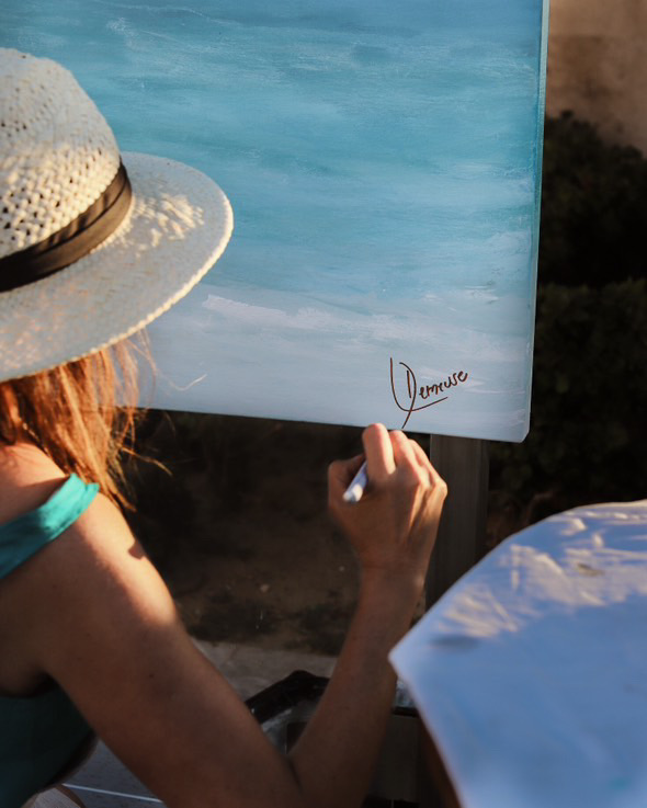 Leticia signing a finished painting